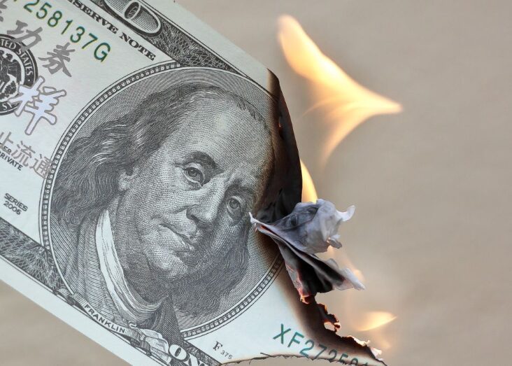 Picture of a burning dollar bill. How to Beat Inflation: A Comprehensive Guide to Smart Investments