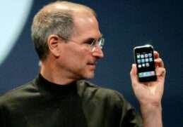 Steve Jobs holding iPhone