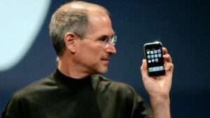Steve Jobs holding iPhone
