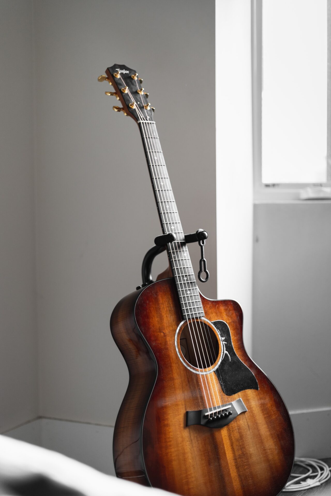 sun bust guitar, placed near the window.