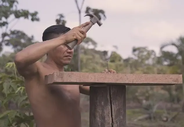 a man holding a hammer - Amazon Tribe Faces Addiction to Prn and Social Media