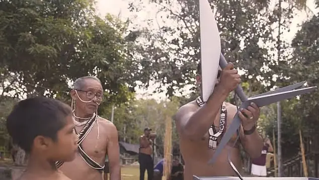 a group of men holding a knife - Amazon Tribe Faces Addiction to Prn and Social Media